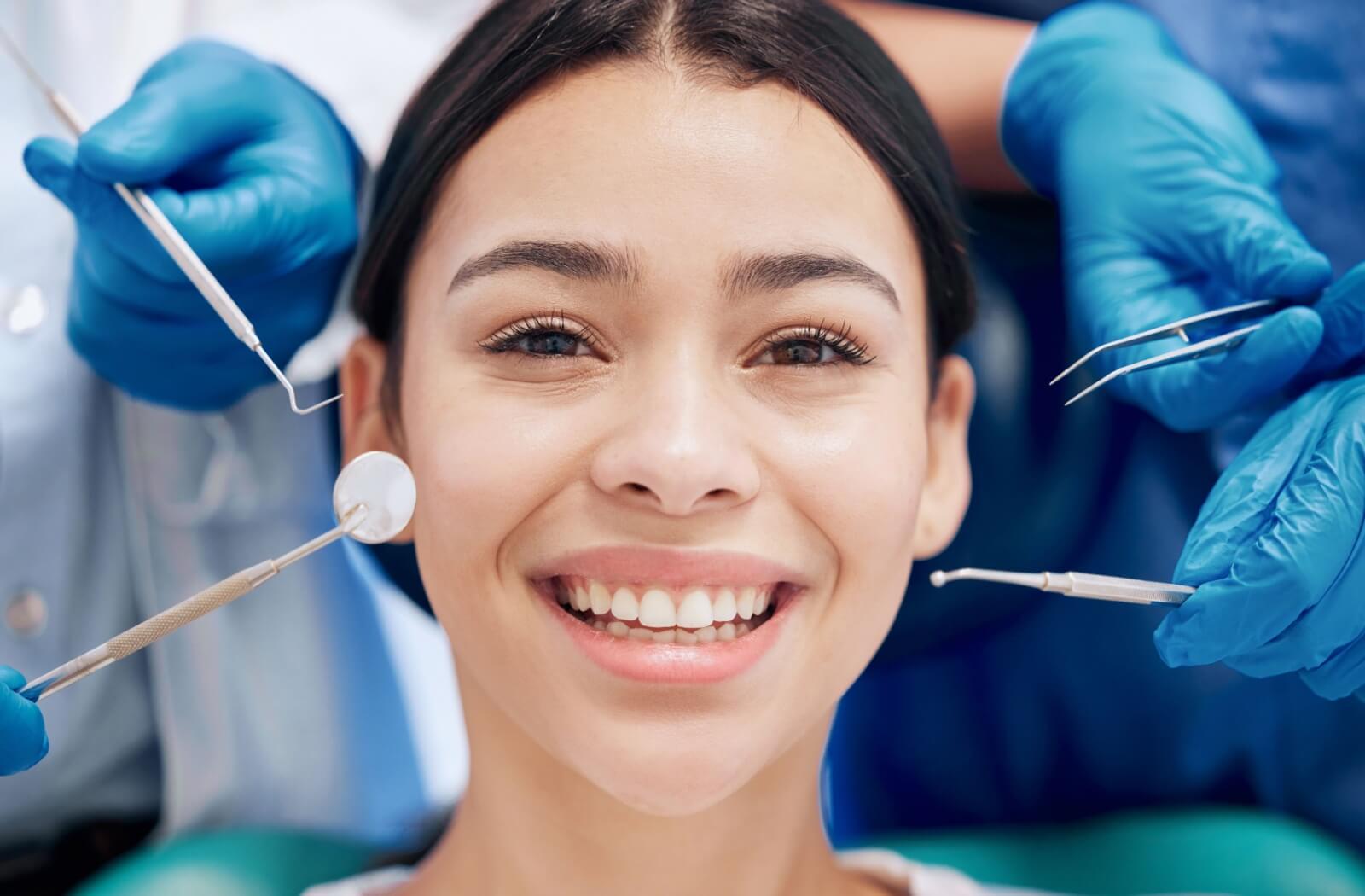 A person sits in the dentist chair, ready for their dental cleaning.